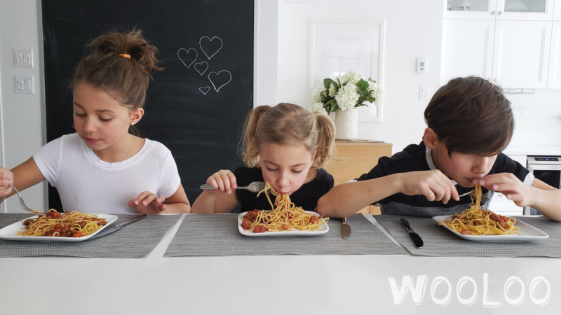 Enfants qui mange une assiette de pâtes avec de la sauce à spaghetti à la mijoteuse